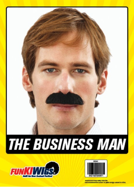 The Business Man Costume Moustache – Black, shown on the original Fun Kiwi packaging