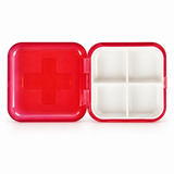 Open red pill container showing four compartments