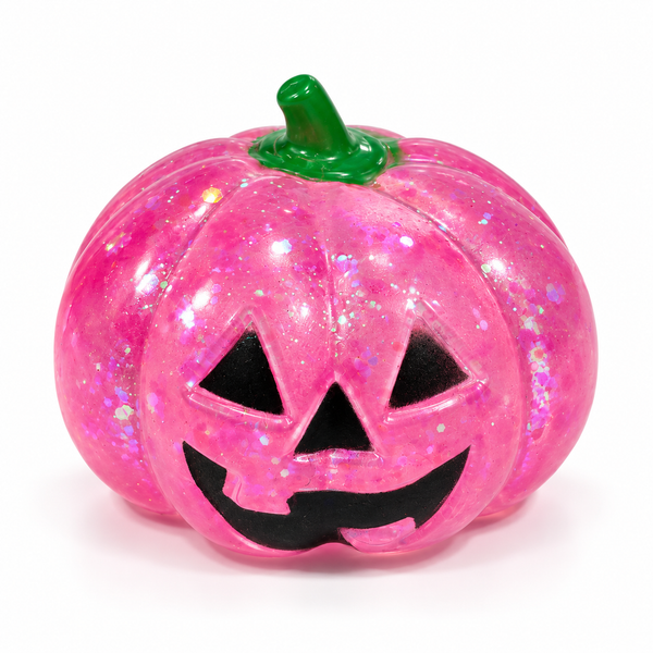 Pink translucent glitter Halloween pumpkin squishy with a jack-o'-lantern face