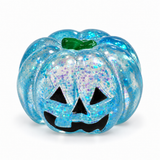 Blue translucent glitter Halloween pumpkin squishy with a jack-o'-lantern face