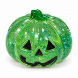 Green translucent glitter Halloween pumpkin squishy with a jack-o'-lantern face